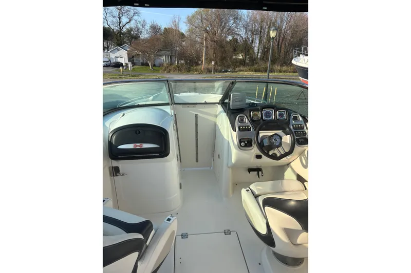 Slide: The Image of 2012 Chaparral 267 SSX boat interior with steering wheel and dashboard controls. - 3