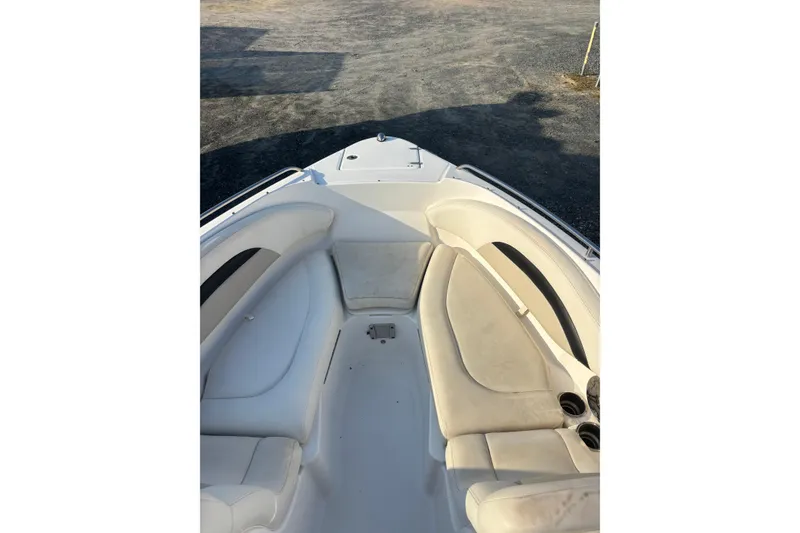 Slide: The Image of 2012 Chaparral 267 SSX boat interior with white seating and cup holders. - 4