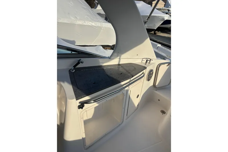 Slide: The Image of 2012 Chaparral 267 SSX boat interior with storage compartment and speaker. - 6