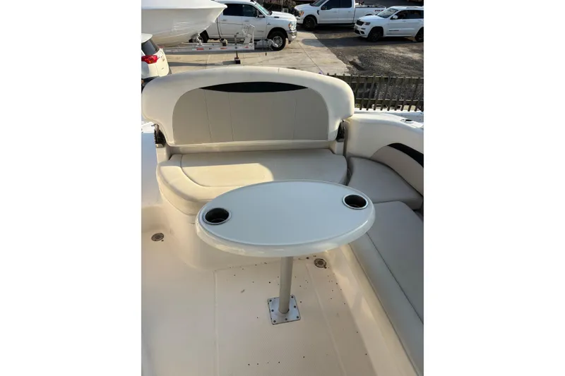 Slide: The Image of Interior seating area of 2012 Chaparral 267 SSX boat with table and cup holders. - 8