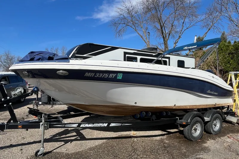 The Image of 2013 Hurricane SunDeck Sport 203 OB boat on trailer, parked outdoors. - 1