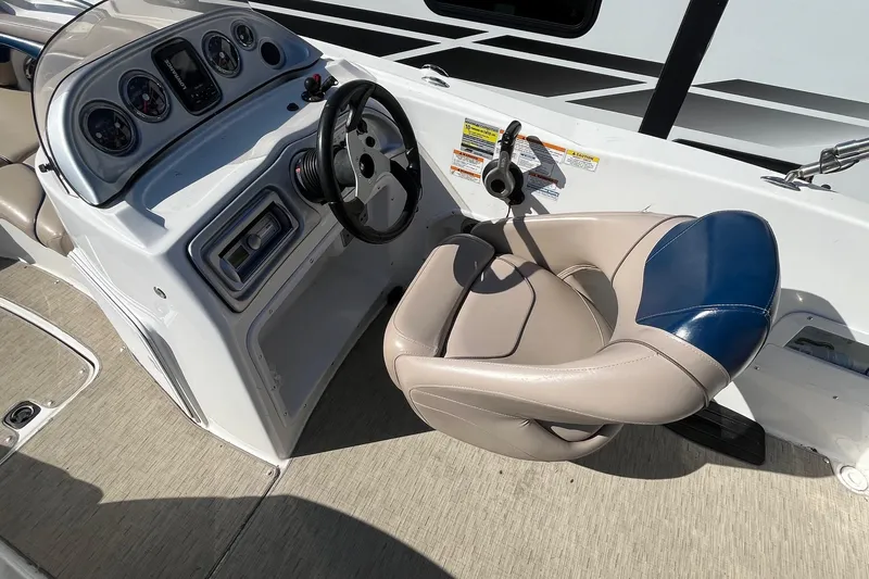 Slide: The Image of 2013 Hurricane SunDeck Sport 203 OB boat cockpit with steering wheel and gauges. - 10