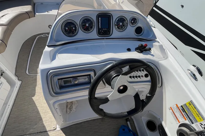 Slide: The Image of 2013 Hurricane SunDeck Sport 203 OB boat dashboard with steering wheel and gauges. - 11