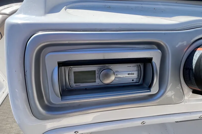 Slide: The Image of 2013 Hurricane SunDeck Sport 203 OB boat dashboard with Clarion stereo system. - 12
