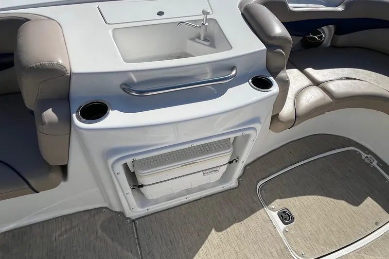 Slide: The Image of 2013 Hurricane SunDeck Sport 203 OB boat interior with sink, cup holders, and seating. - 14