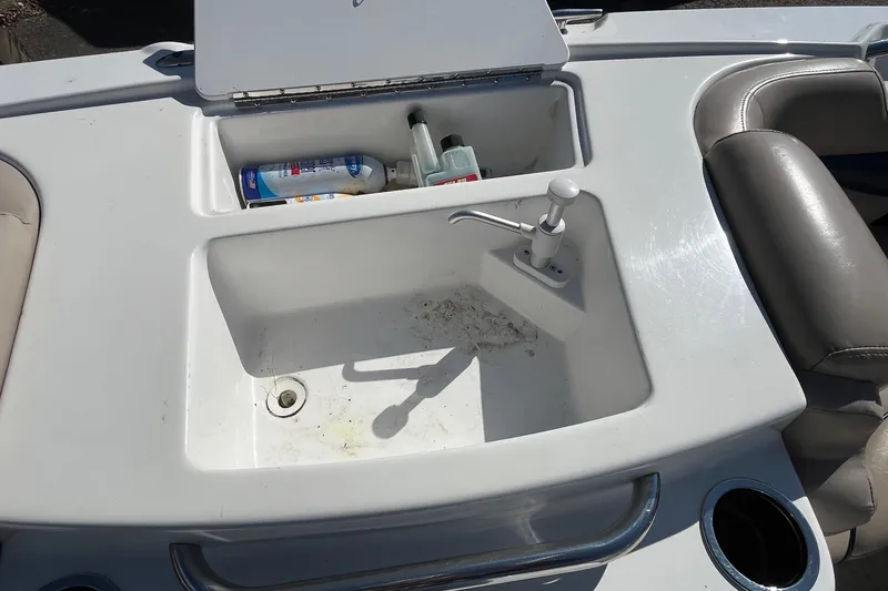 Slide: The Image of 2013 Hurricane SunDeck Sport 203 OB boat sink with storage compartment and faucet. - 15
