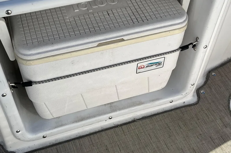 Slide: The Image of White marine cooler secured on a 2013 Hurricane SunDeck Sport 203 OB boat. - 16
