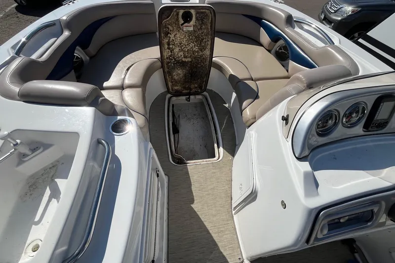 Slide: The Image of 2013 Hurricane SunDeck Sport 203 OB interior with seating and open storage compartment. - 17