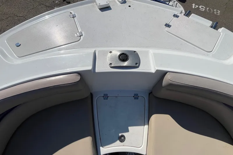 Slide: The Image of 2013 Hurricane SunDeck Sport 203 OB boat interior with seating and storage compartments. - 19