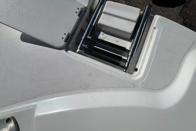 Slide: The Image of 2013 Hurricane SunDeck Sport 203 OB boat ladder and deck detail. - 20