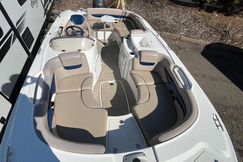 Slide: The Image of 2013 Hurricane SunDeck Sport 203 OB boat interior with beige seating and steering console. - 21
