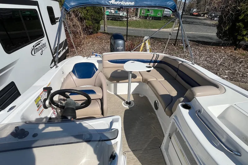 Slide: The Image of 2013 Hurricane SunDeck Sport 203 OB boat interior with seating and steering wheel. - 22