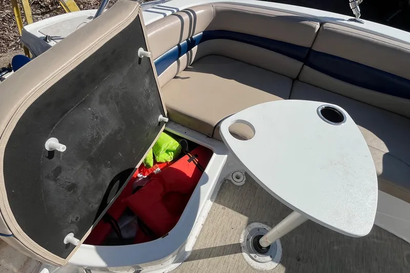 Slide: The Image of 2013 Hurricane SunDeck Sport 203 OB boat interior with storage compartment and table. - 23