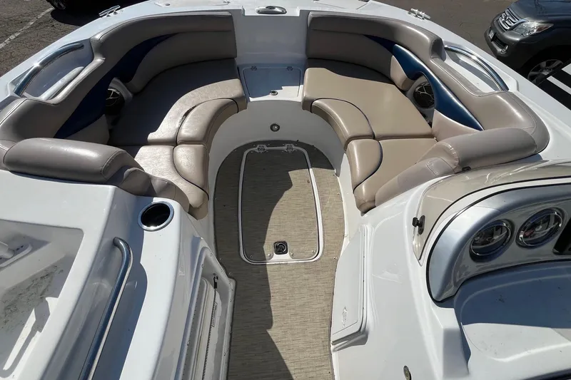 Slide: The Image of 2013 Hurricane SunDeck Sport 203 OB boat interior with cushioned seating and dashboard. - 6