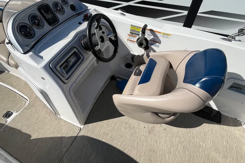 Slide: The Image of 2013 Hurricane SunDeck Sport 203 OB boat cockpit with steering wheel and gauges. - 8