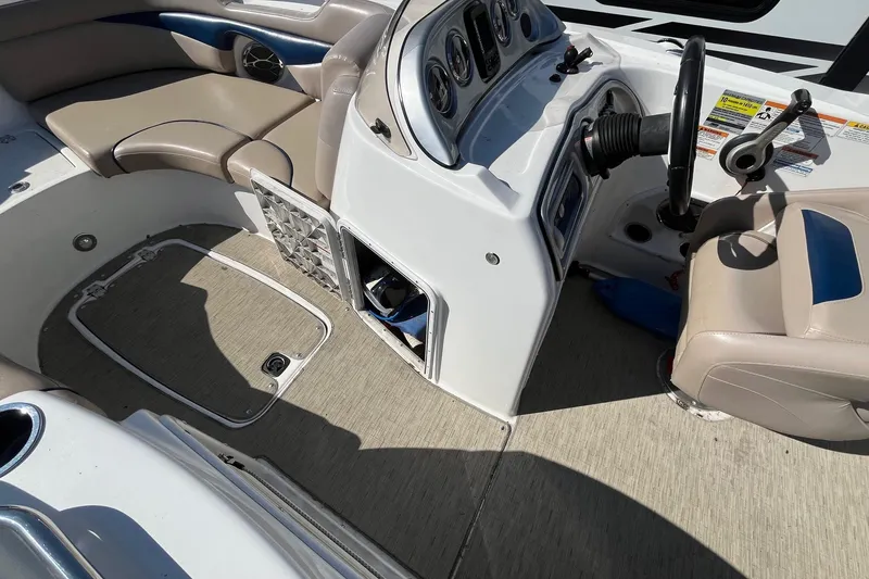 Slide: The Image of 2013 Hurricane SunDeck Sport 203 OB boat interior with steering console and seating. - 9