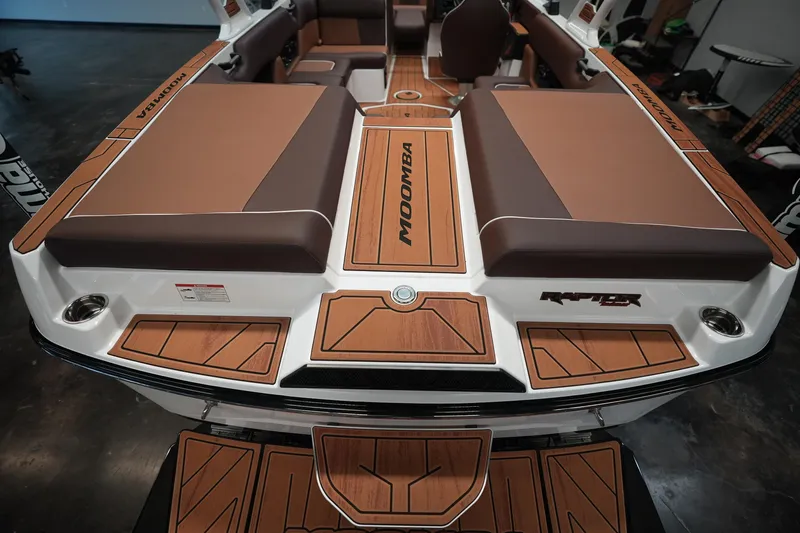 Slide: The Image of 2026 Moomba Craz boat interior with brown upholstery and wood accents. - 3