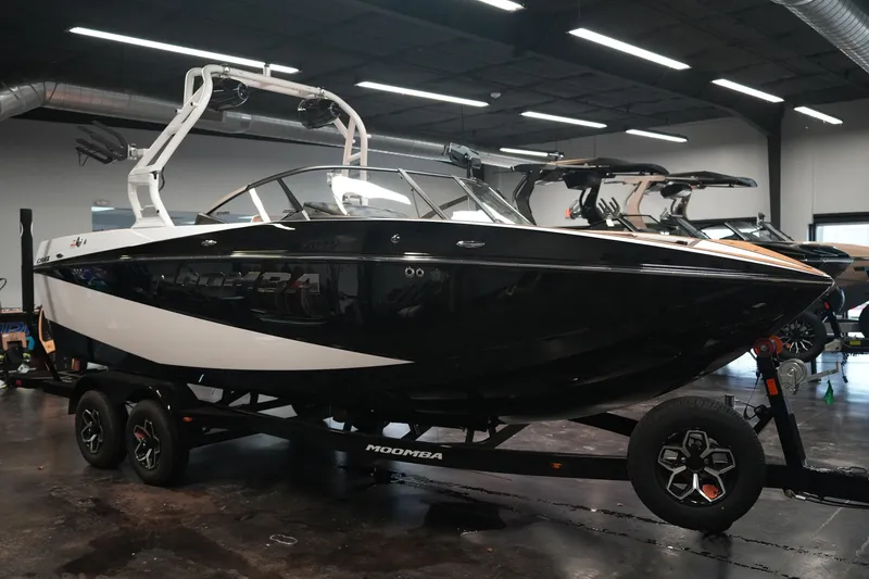 Slide: The Image of 2026 Moomba Craz boat in showroom, black and white design. - 7