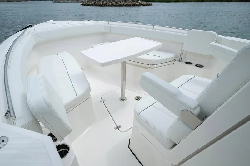 Slide: The Image of Manufacturer Provided Image: 2022 Pursuit S 268 Sport boat interior with white seating and table. - 9
