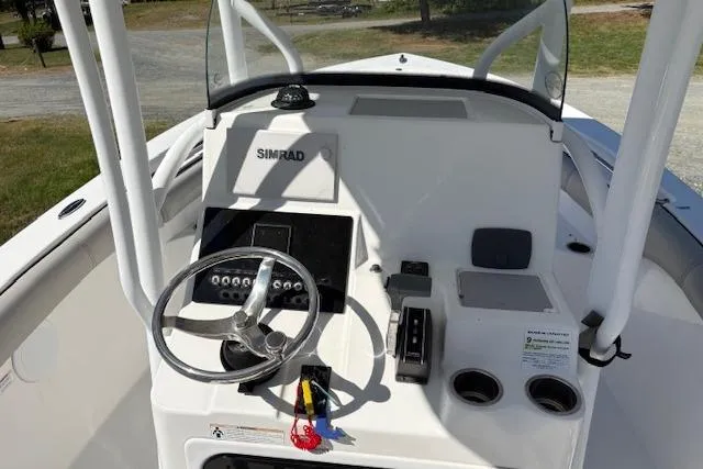 Slide: The Image of 2018 Sea Pro 219 Center Console boat dashboard with steering wheel and Simrad electronics. - 10