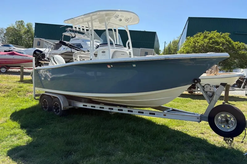 Slide: The Image of 2018 Sea Pro 219 Center Console boat on trailer, parked on grass. - 2