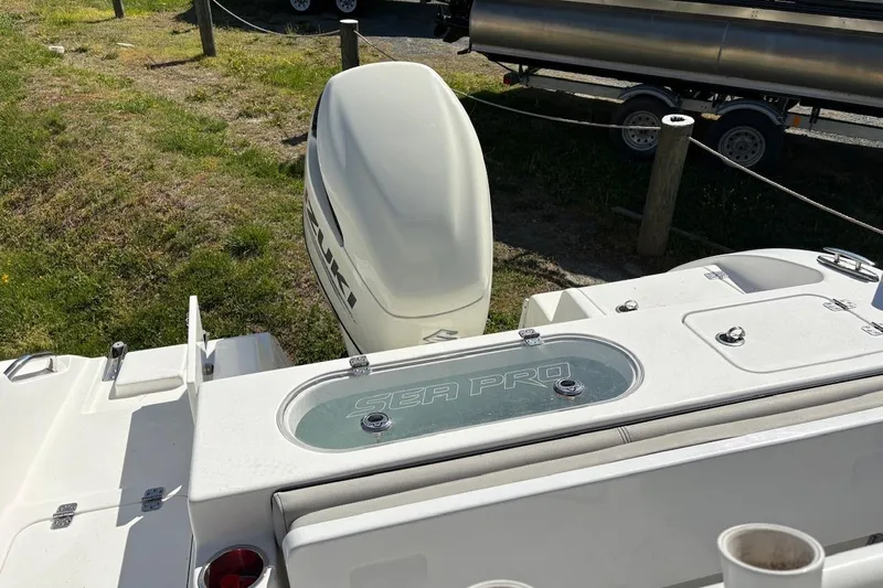 Slide: The Image of 2018 Sea Pro 219 Center Console boat with Suzuki outboard motor, parked on grass. - 4