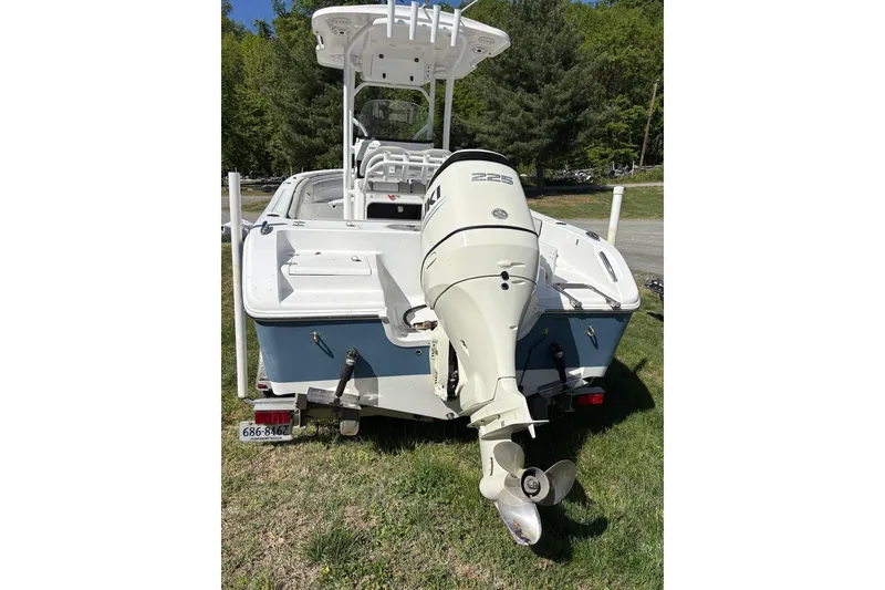 Slide: The Image of 2018 Sea Pro 219 Center Console boat with outboard motor, parked on grass. - 5