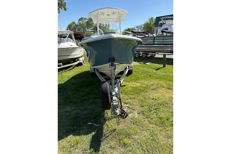 Slide: The Image of 2018 Sea Pro 219 Center Console boat on trailer, parked on grass. - 7