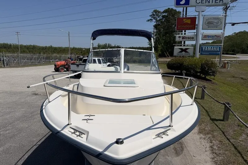 Slide: The Image of 2003 Sea Hunt Victory 215 boat parked near dealership signs. - 11
