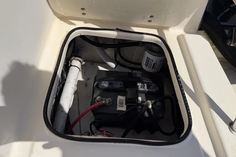 Slide: The Image of Battery compartment of a 2003 Sea Hunt Victory 215 boat, showing wiring and filter. - 12