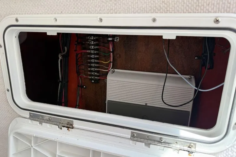 Slide: The Image of Electrical panel inside a 2003 Sea Hunt Victory 215 boat, showcasing wiring and components. - 14