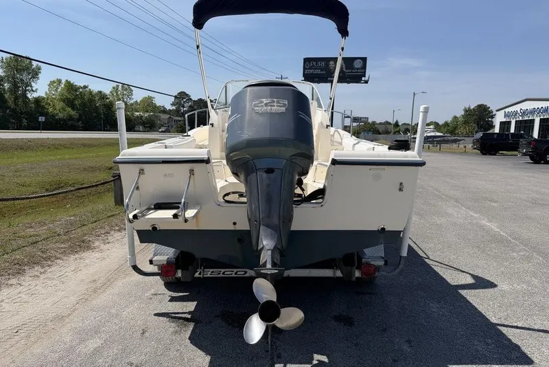 Slide: The Image of 2003 Sea Hunt Victory 215 boat with outboard motor, parked on a trailer. - 16