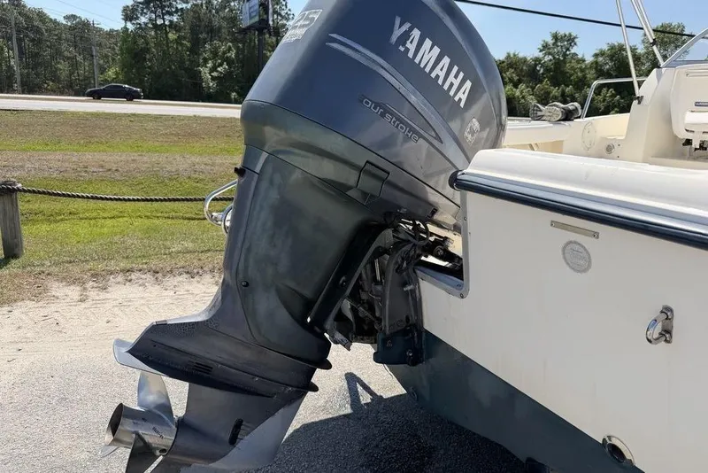 Slide: The Image of 2003 Sea Hunt Victory 215 boat with Yamaha outboard motor in a sunny outdoor setting. - 4