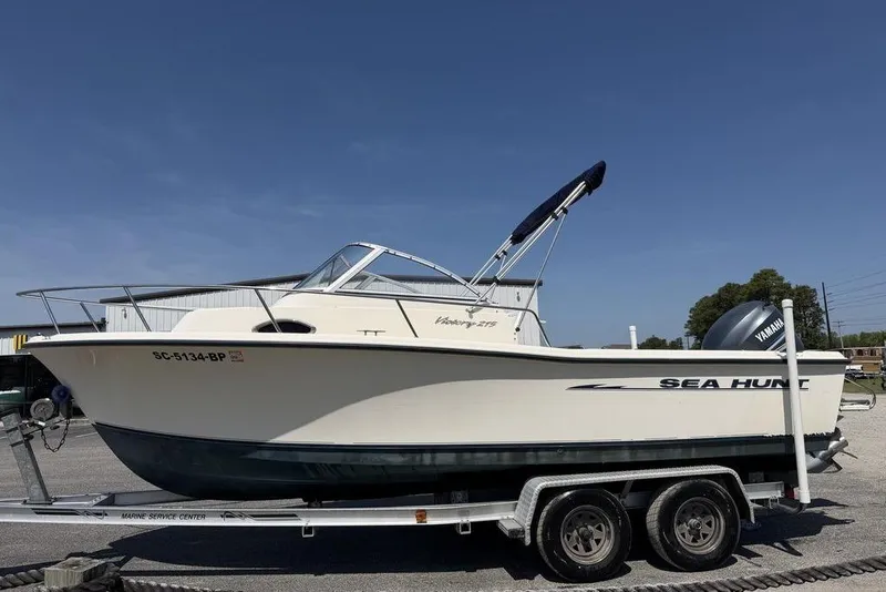 Slide: The Image of 2003 Sea Hunt Victory 215 boat on trailer, side view, clear sky background. - 5