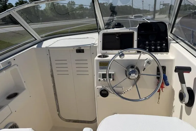 Slide: The Image of 2003 Sea Hunt Victory 215 boat cockpit with steering wheel and navigation equipment. - 9