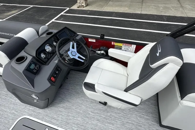 Slide: The Image of 2026 Bennington S Swingback 22 SSB boat interior with steering wheel and captain's chair. - 17