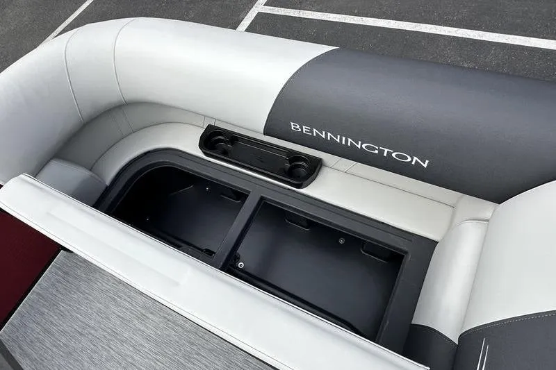 Slide: The Image of 2026 Bennington S Swingback 22 SSB boat interior with storage compartment and cup holders. - 23