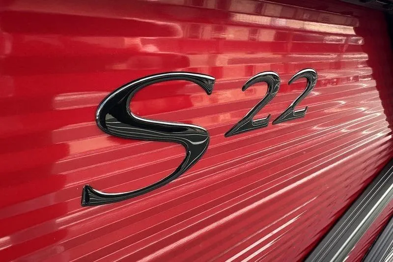 Slide: The Image of Close-up of 2026 Bennington S Swingback 22 SSB logo on red surface. - 24