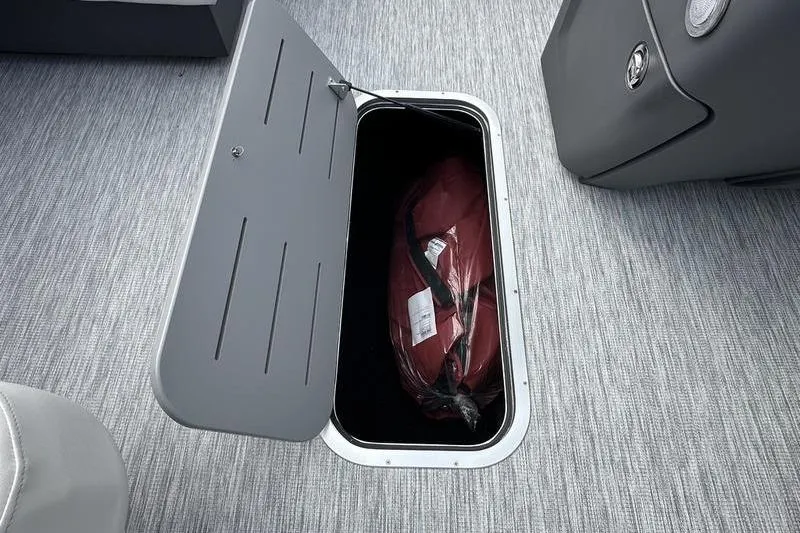 Slide: The Image of Storage compartment on 2026 Bennington S Swingback 22 SSB boat with red bag inside. - 29