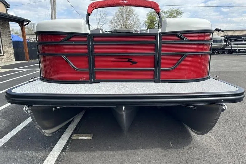 Slide: The Image of 2026 Bennington S Swingback 22 SSB pontoon boat, red exterior, parked on asphalt. - 9