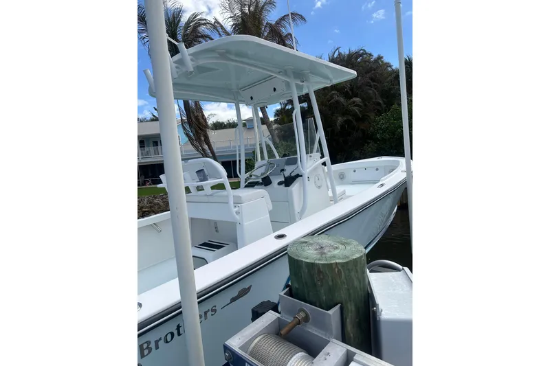 Slide: The Image of 2018 Albury Brothers 23 boat docked, featuring a sleek white design and spacious deck. - 3