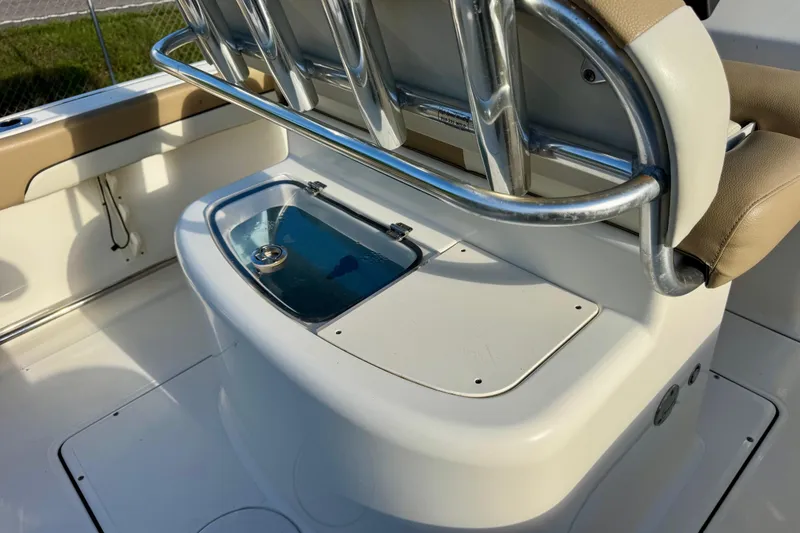 Slide: The Image of 2019 Pioneer 222 Sportfish boat interior with seating and storage compartment. - 11