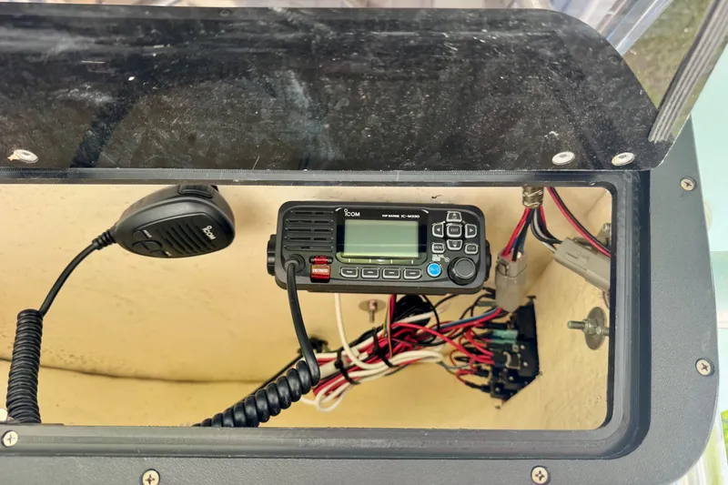 Slide: The Image of VHF radio setup inside a 2019 Pioneer 222 Sportfish boat console. - 14