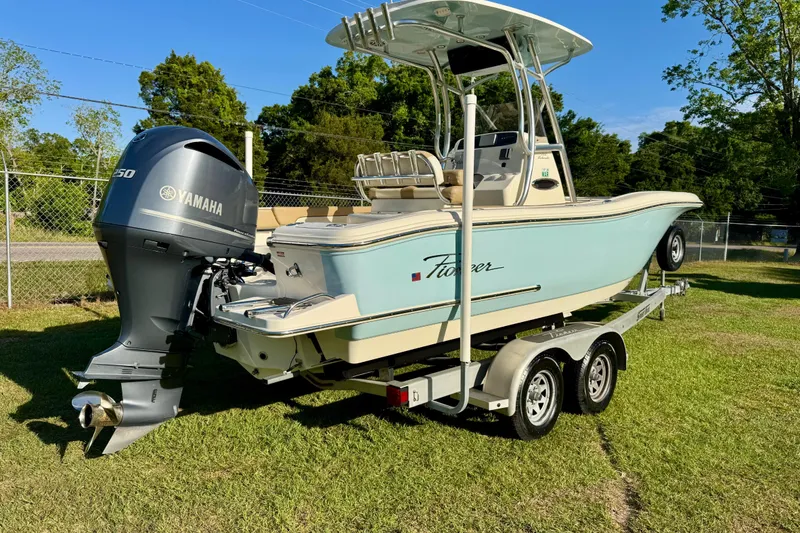 Slide: The Image of 2019 Pioneer 222 Sportfish boat with Yamaha engine on trailer, parked on grass. - 3