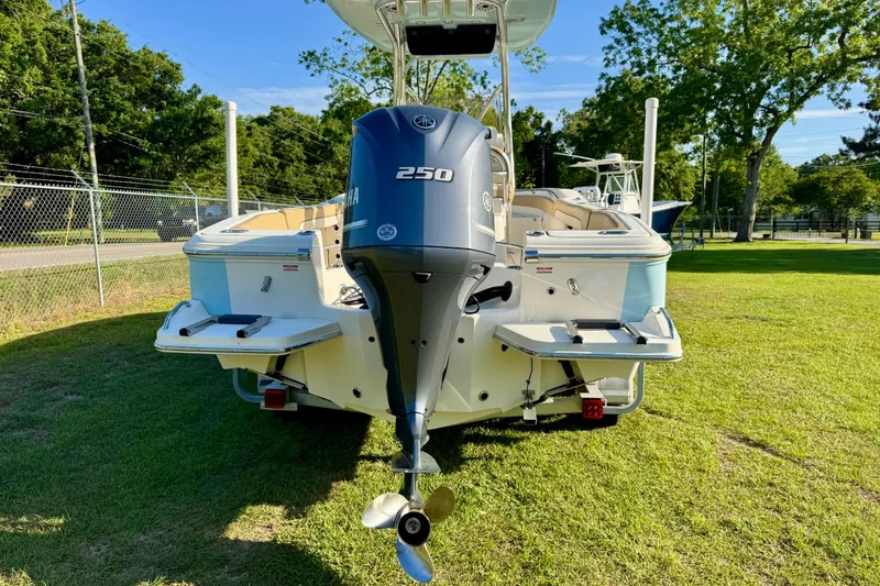 Slide: The Image of 2019 Pioneer 222 Sportfish boat with Yamaha 250 engine, parked on grass. - 4
