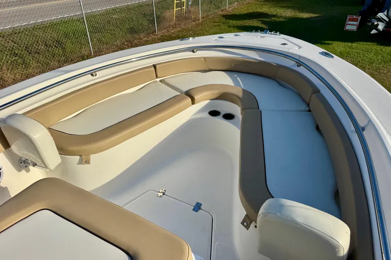 Slide: The Image of 2019 Pioneer 222 Sportfish boat interior with beige seating and cup holders. - 5
