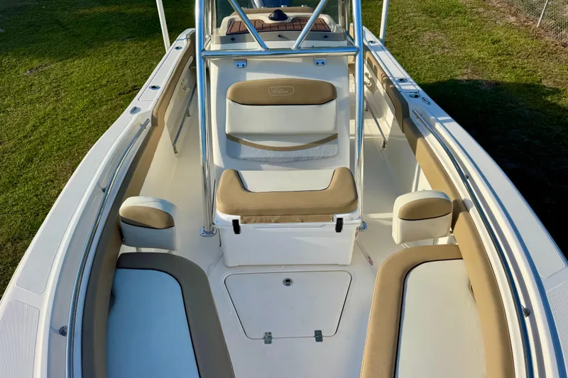 Slide: The Image of 2019 Pioneer 222 Sportfish boat interior with beige seating and stainless steel railings. - 6