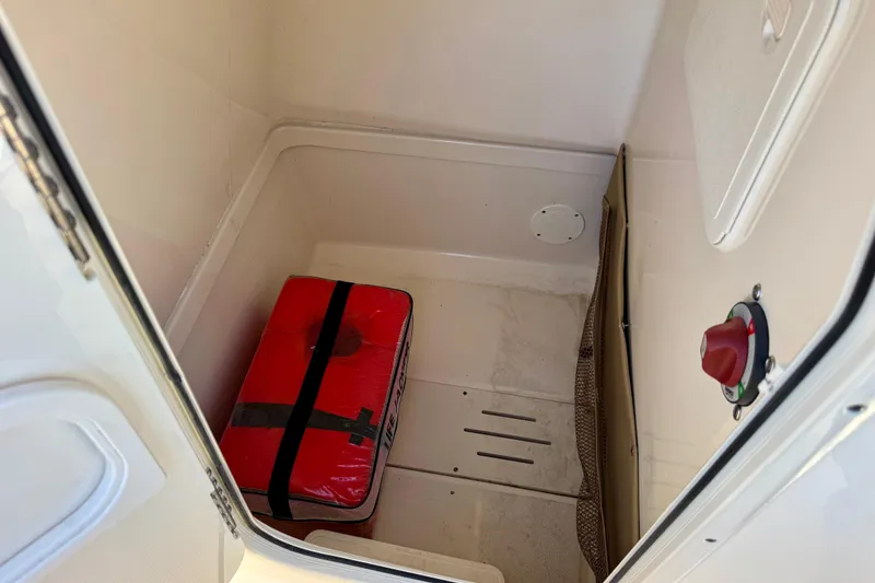 Slide: The Image of Storage compartment of 2019 Pioneer 222 Sportfish boat with red life jacket. - 8
