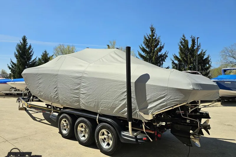 Slide: The Image of 2001 Powerquest 340 Vyper boat covered on trailer, parked outdoors. - 101