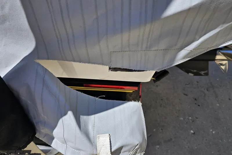 Slide: The Image of Torn cover on a 2001 Powerquest 340 Vyper boat, exposing interior details. - 102